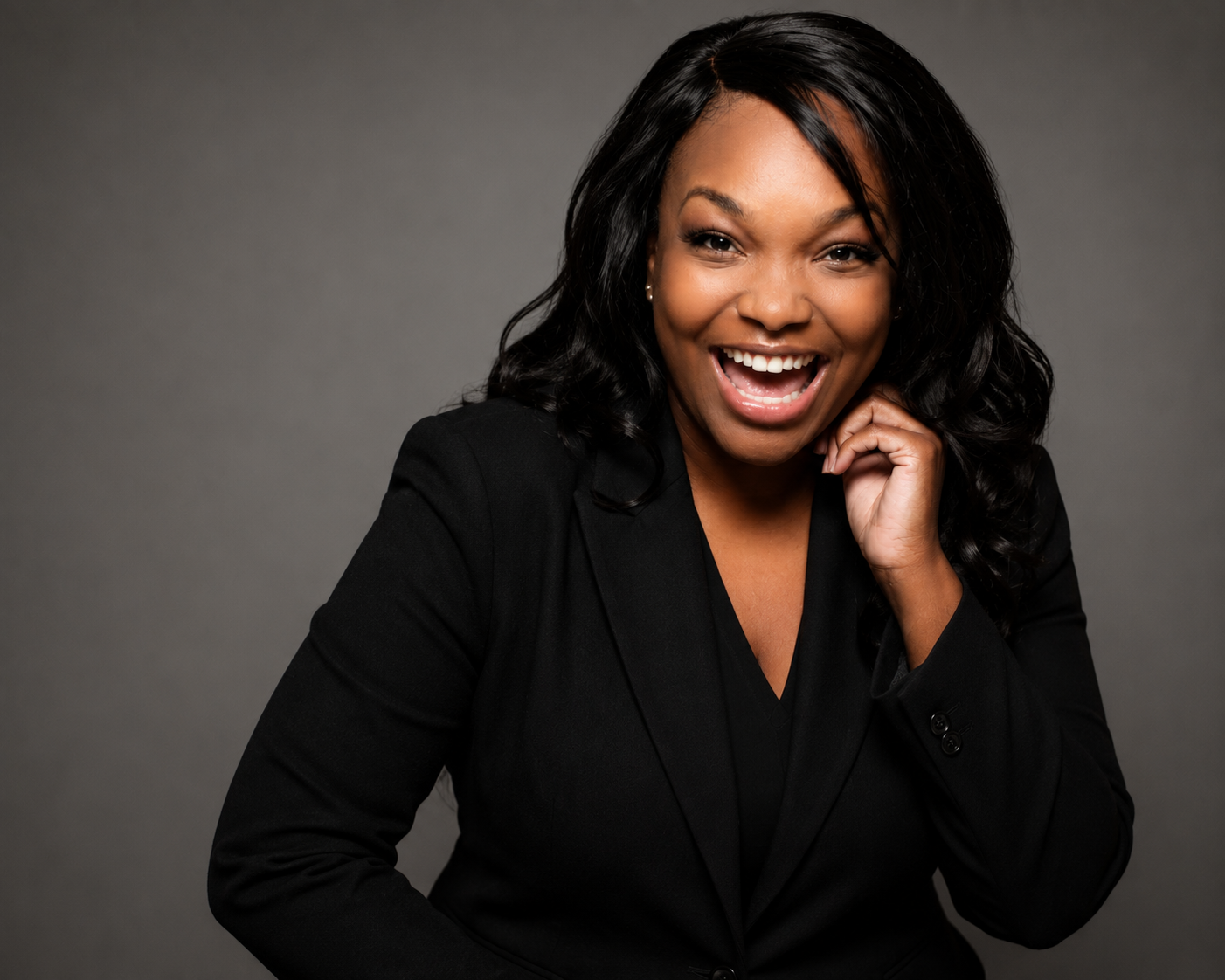 Tuesday Lewis-Harris smiling in a black blazer